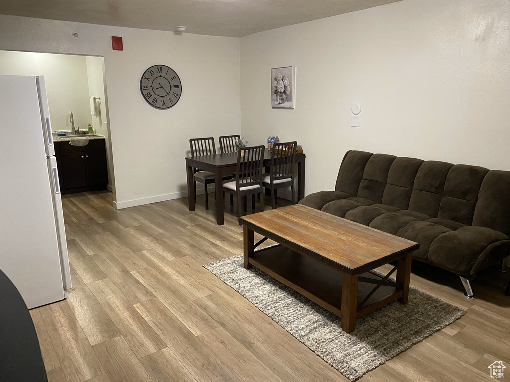 Living room with light wood-style flooring and baseboards