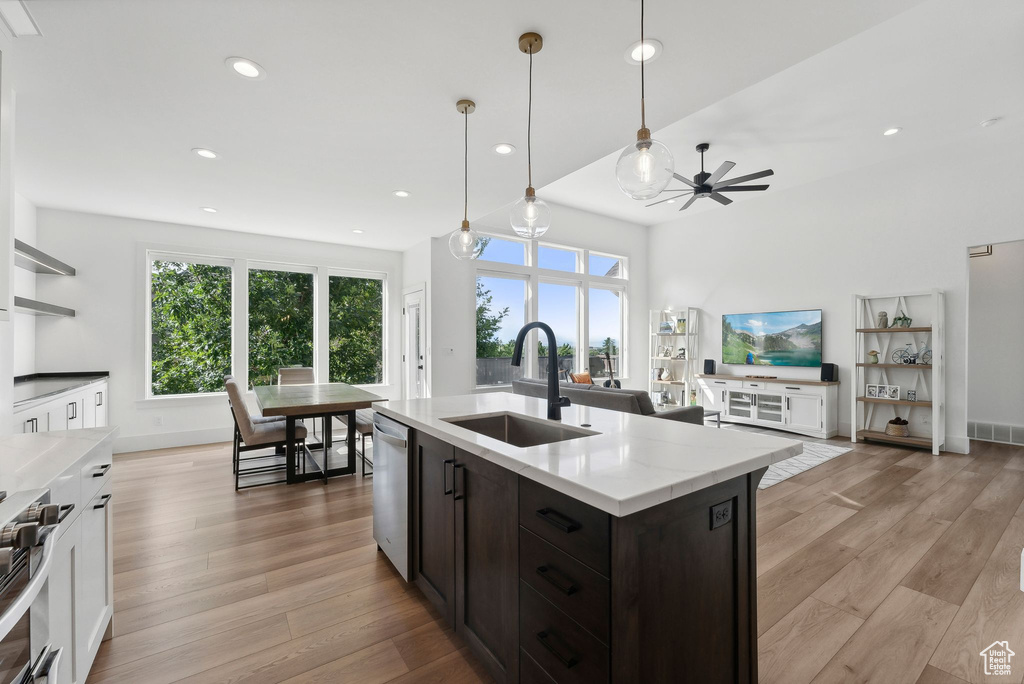 Kitchen featuring a sink, stainless steel appliances, recessed lighting, light wood finished floors, and a ceiling fan