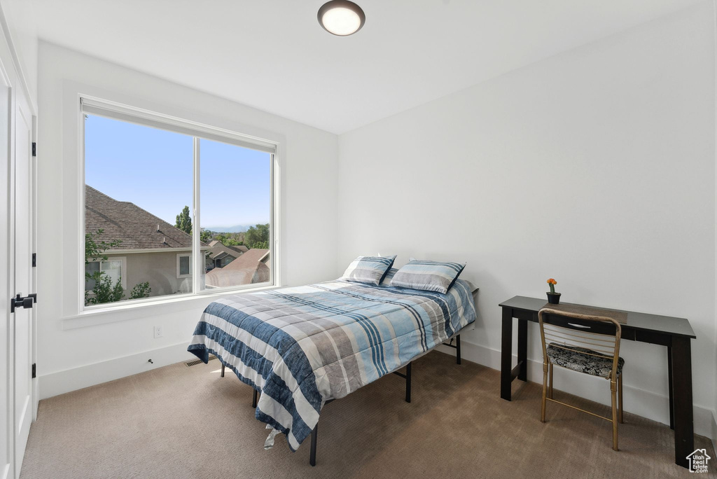 Carpeted bedroom featuring baseboards
