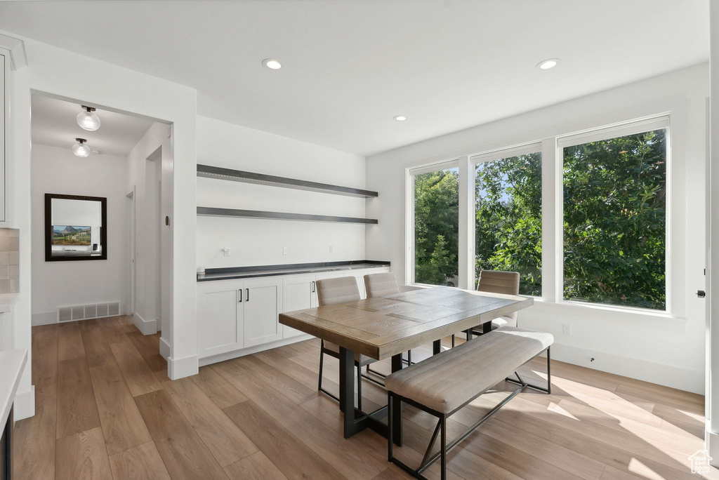 Dining room with light wood-style floors, recessed lighting, and baseboards