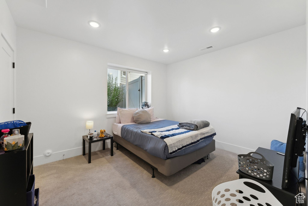 Bedroom featuring light colored carpet, baseboards, and recessed lighting