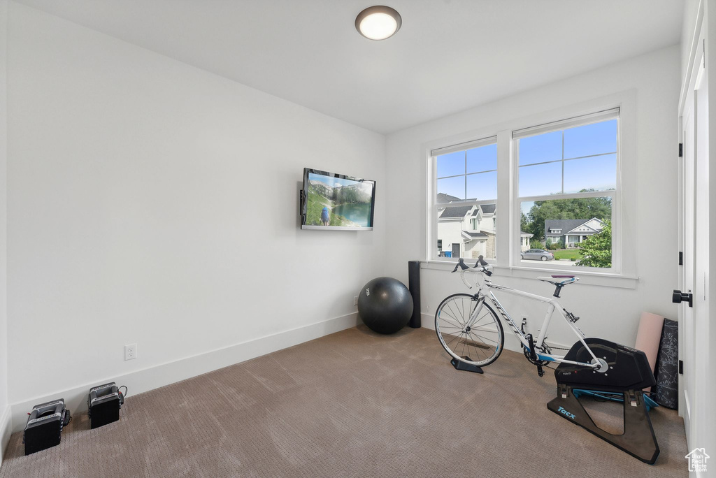 Exercise area featuring carpet and baseboards