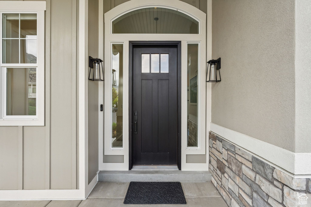 View of exterior entry featuring stone siding