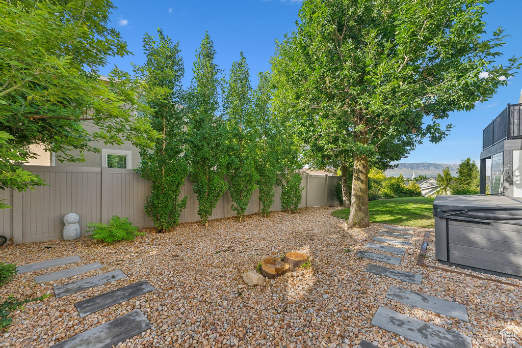 View of yard with a hot tub
