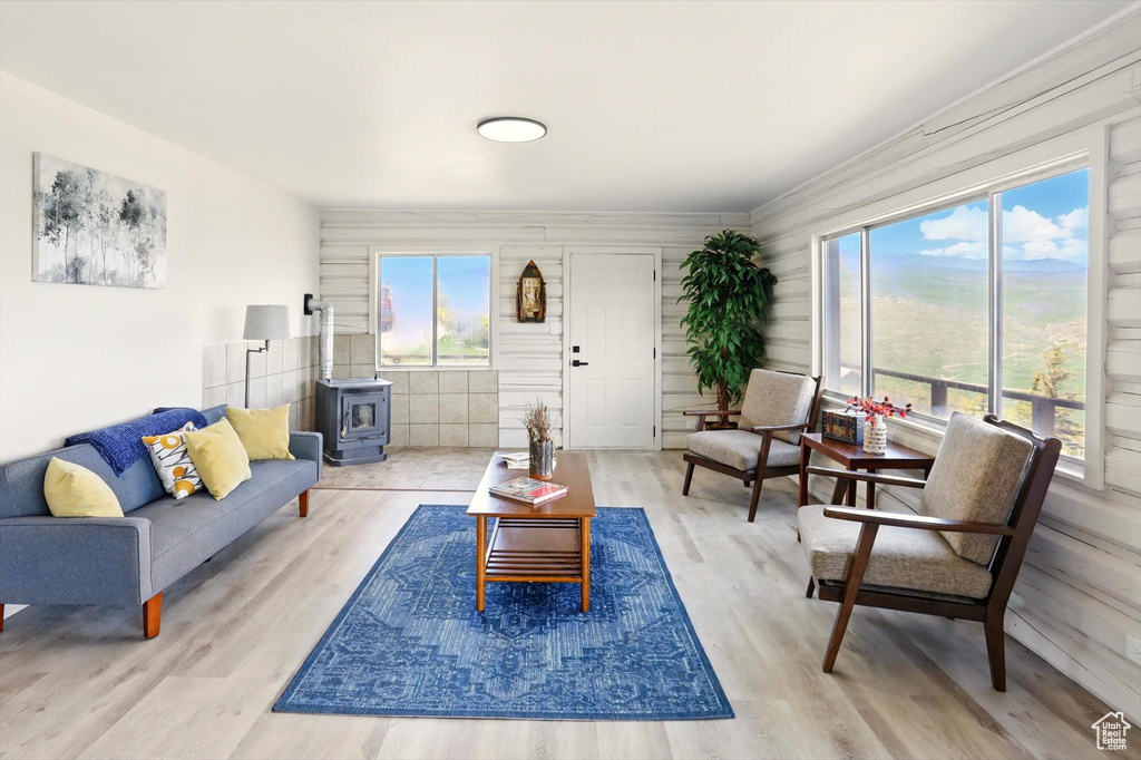 Living area featuring a wood stove and wood finished floors