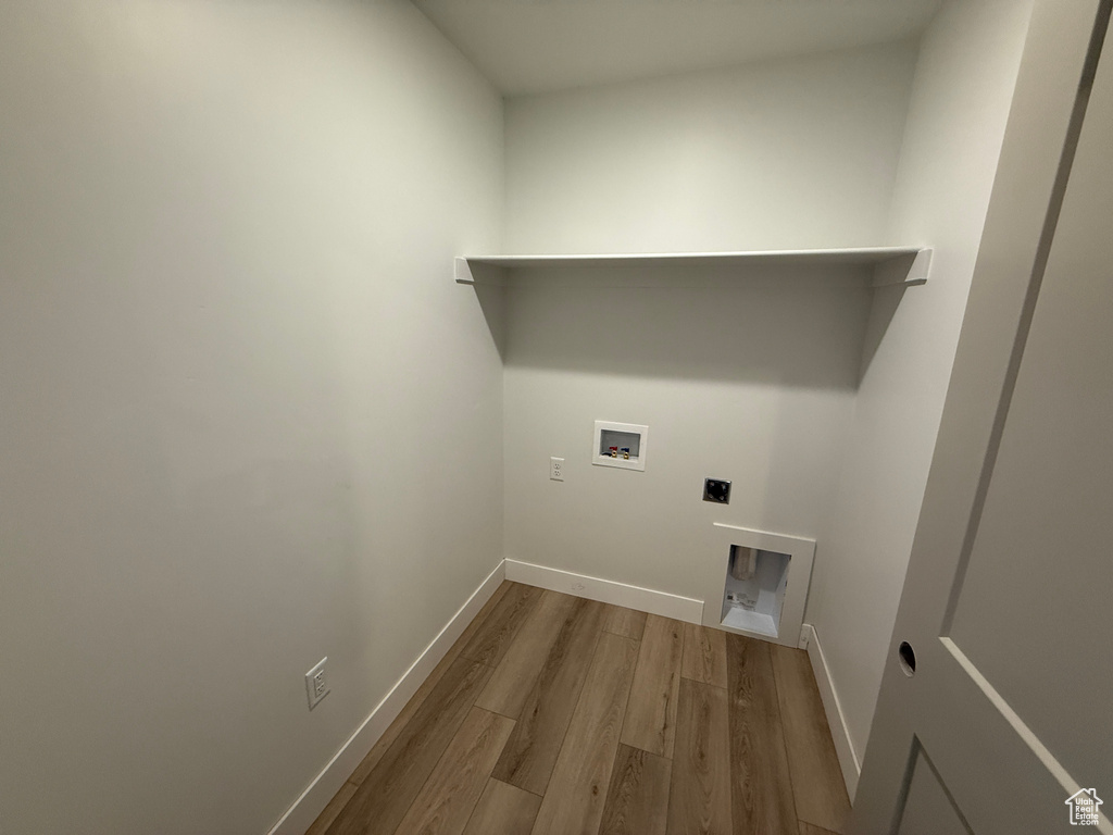 Laundry room featuring wood finished floors, electric dryer hookup, washer hookup, and baseboards