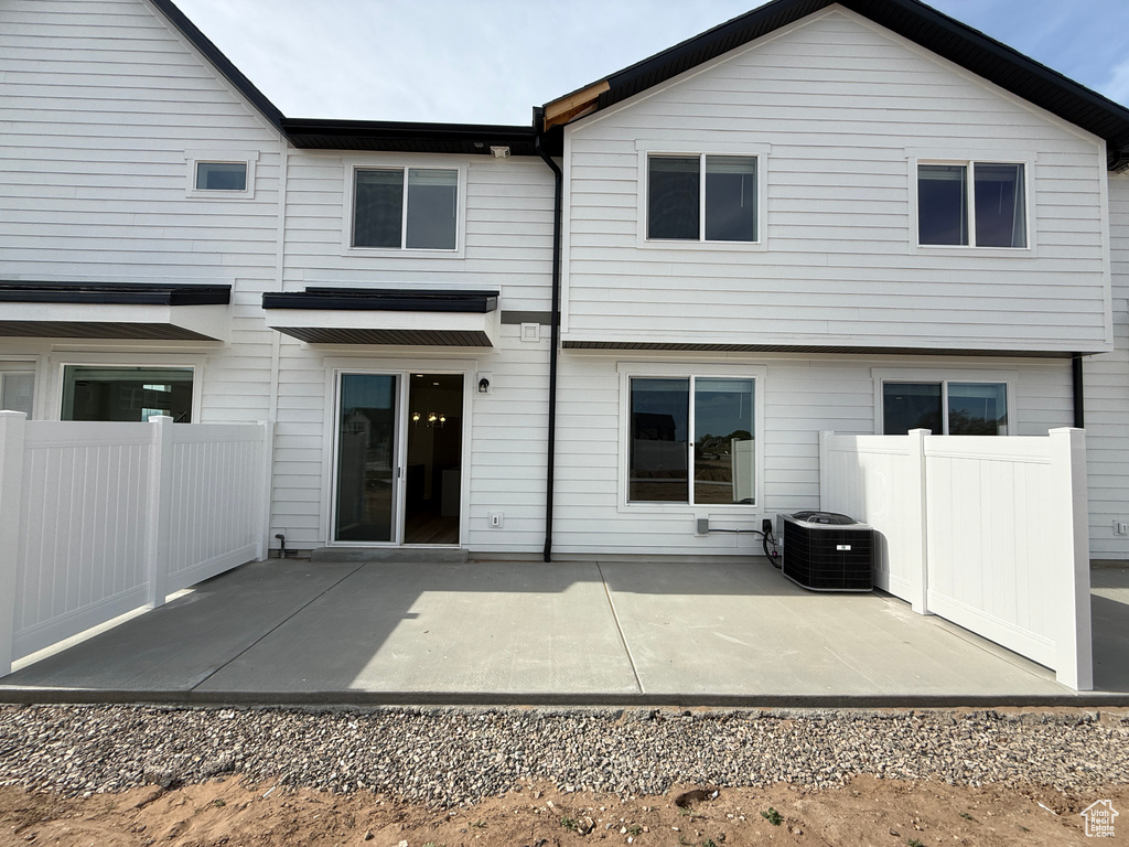 Rear view of property featuring cooling unit and a patio area