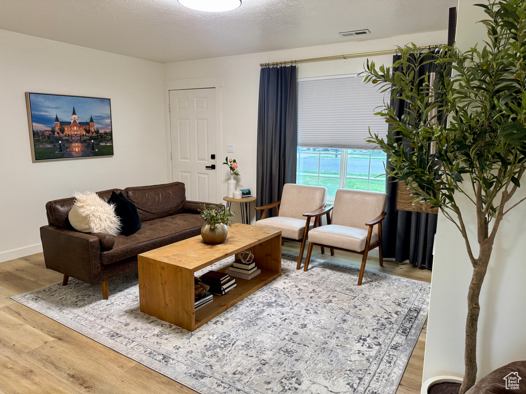 Living room featuring light wood-style floors and baseboards