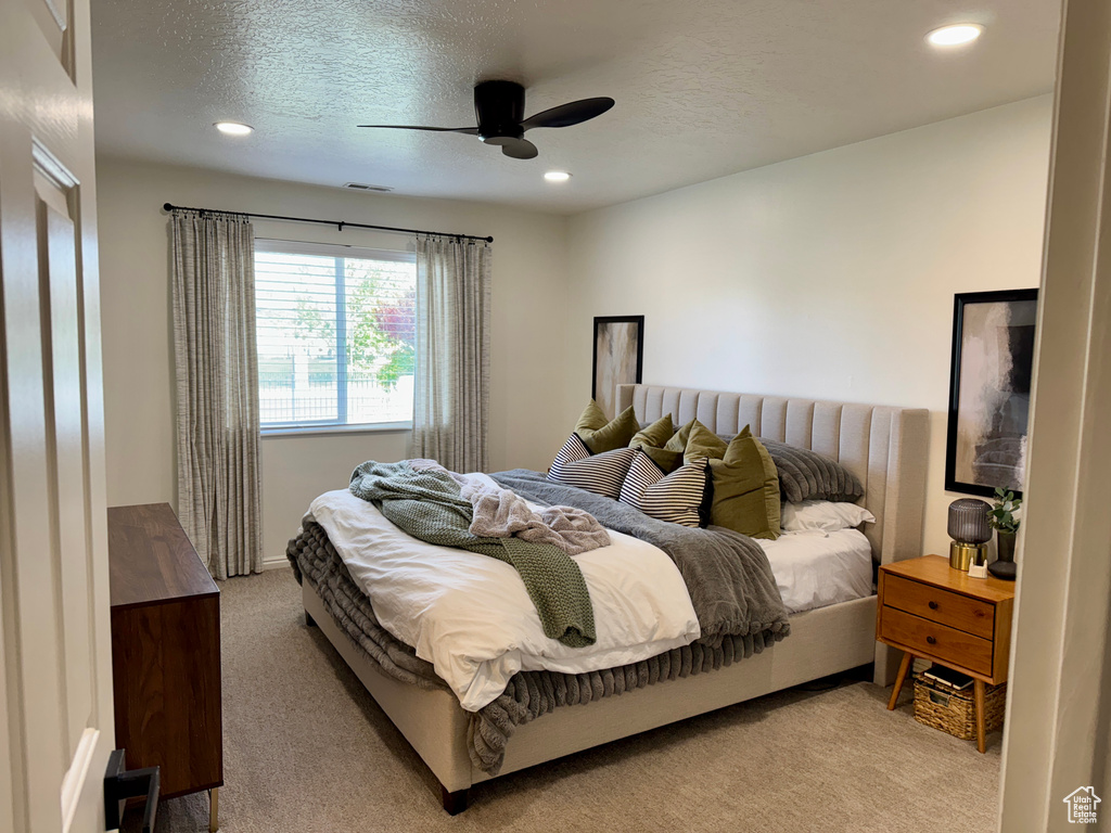 Carpeted bedroom featuring recessed lighting, a ceiling fan, and a textured ceiling