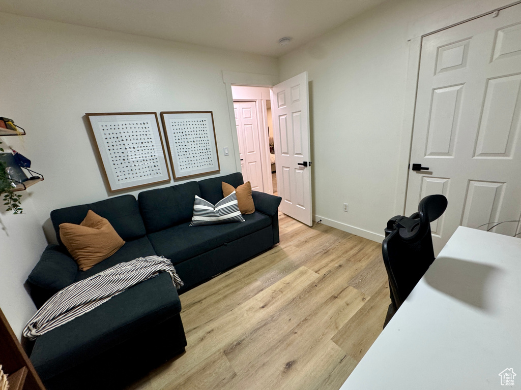 Living area featuring light wood-style flooring and baseboards