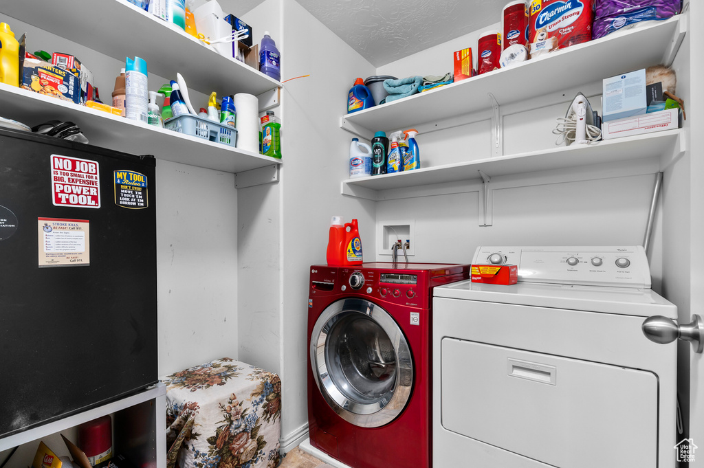 Washroom featuring separate washer and dryer and baseboards