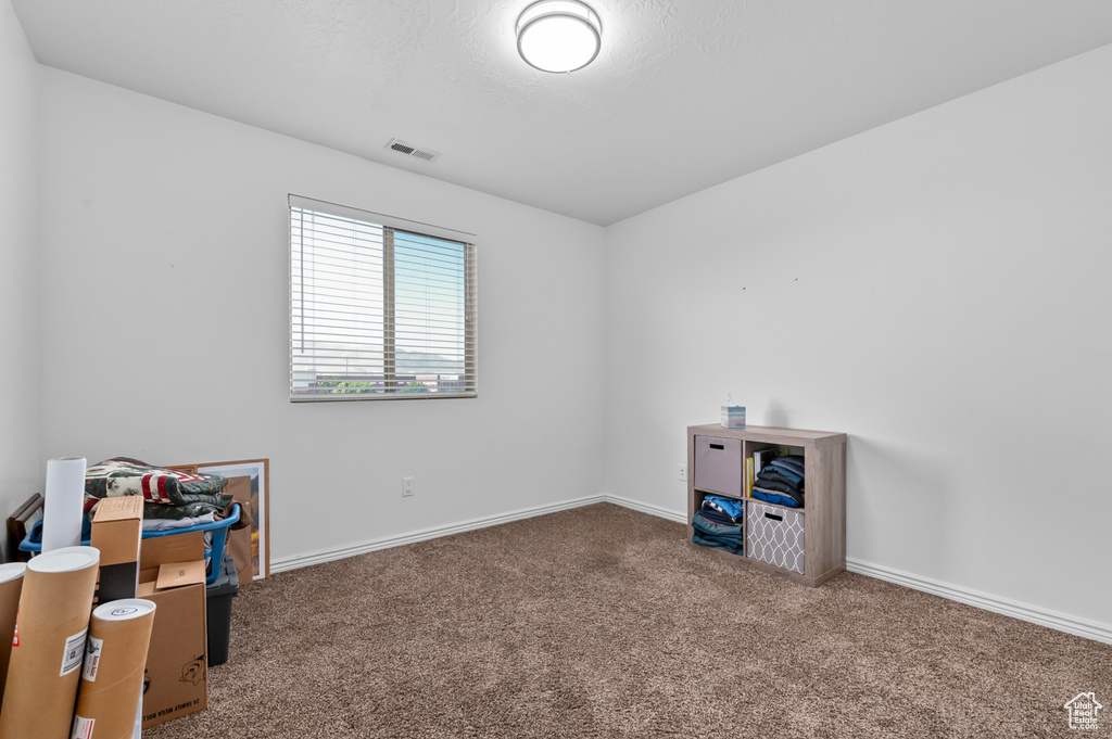 Misc room featuring carpet and baseboards