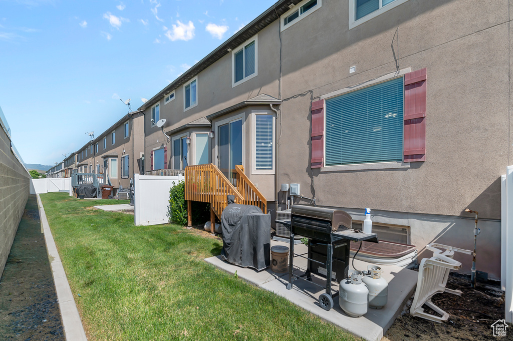 Rear view of property with stucco siding and a residential view