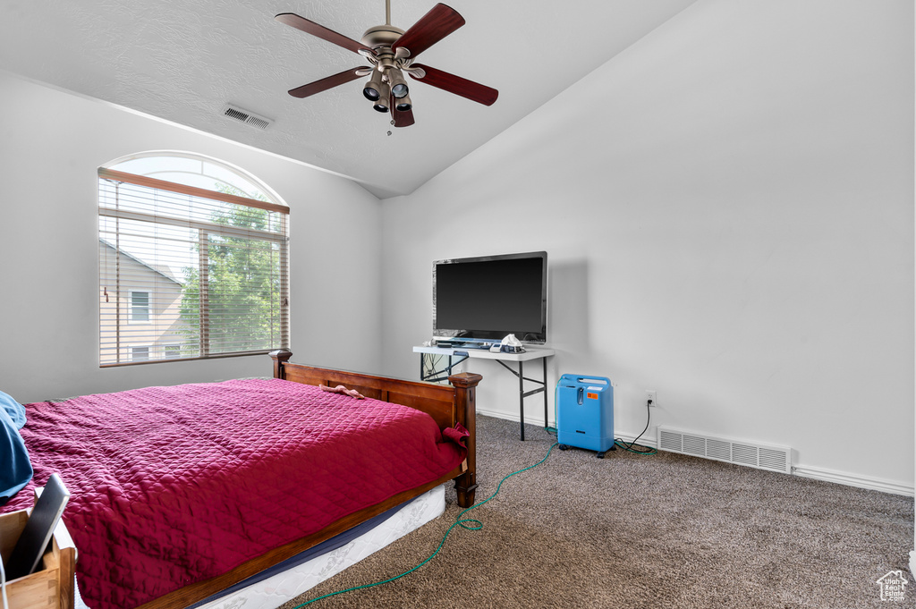 Bedroom featuring carpet floors, vaulted ceiling, ceiling fan, and baseboards