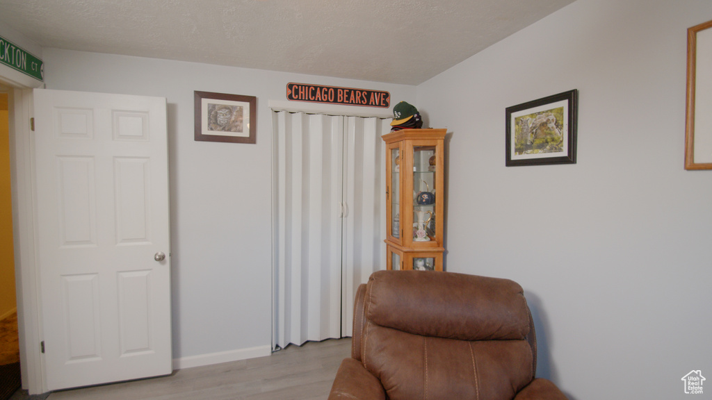 Living area with light wood-style floors and baseboards
