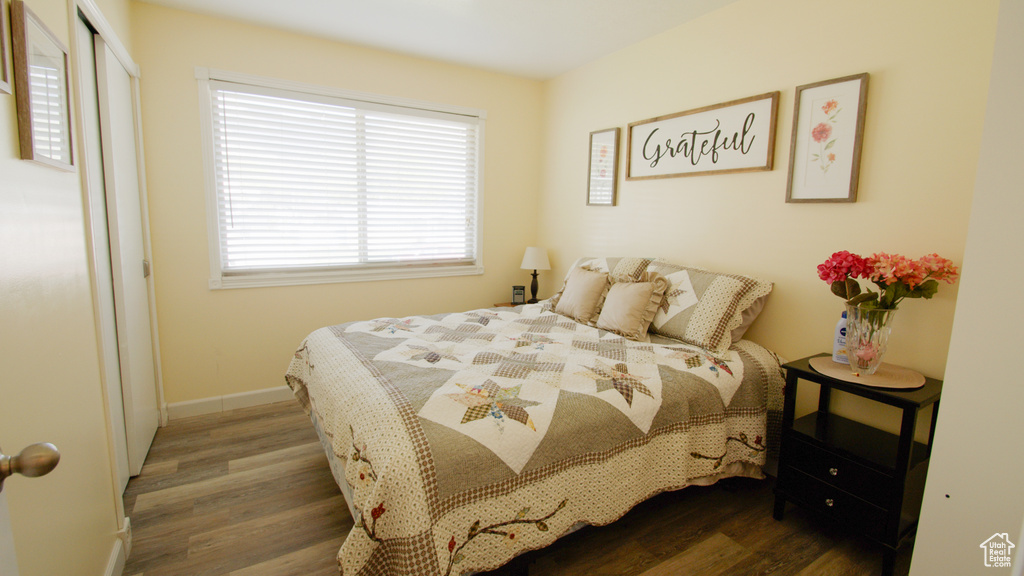 Bedroom featuring wood finished floors and baseboards