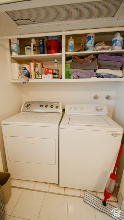 Laundry area featuring separate washer and dryer and tile patterned floors