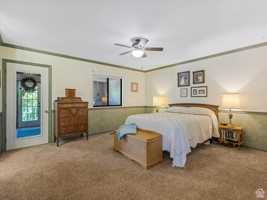Bedroom with carpet, crown molding, and ceiling fan