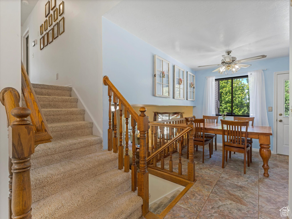Dining space featuring stairway and ceiling fan