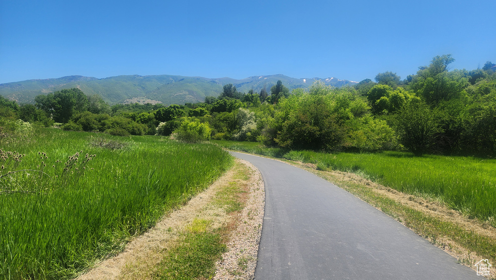 View of asphalt street featuring a mountain view