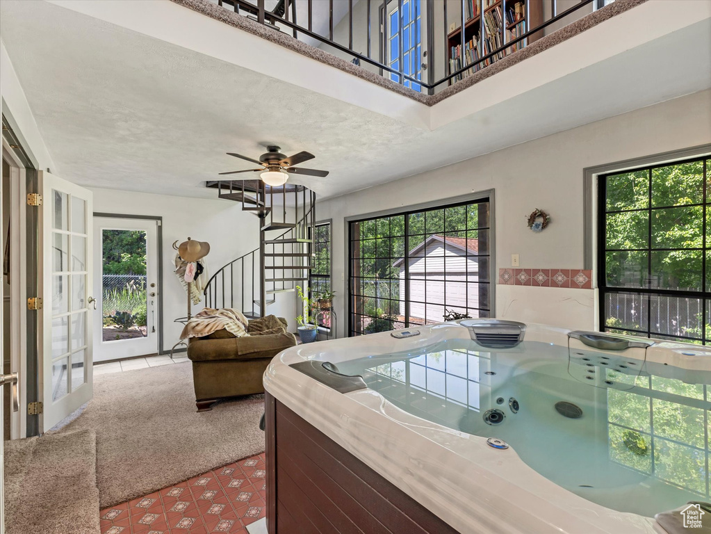 Interior space with stairs, carpet, and french doors