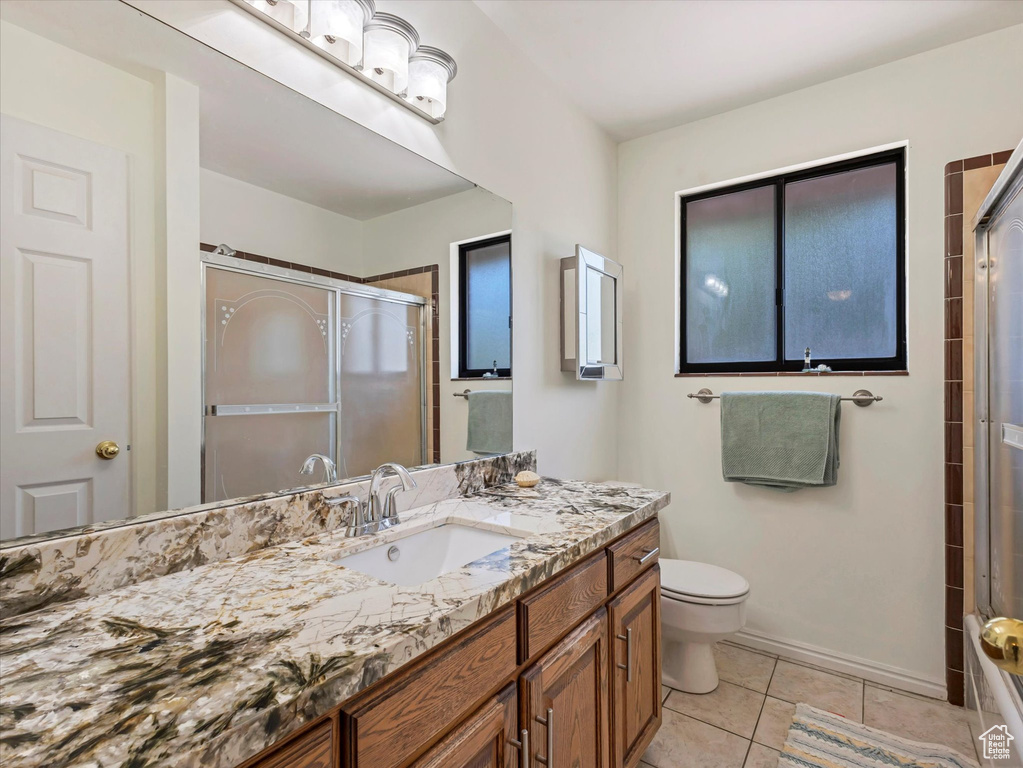 Full bath with vanity, toilet, and tile patterned floors