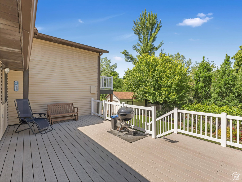 Wooden deck featuring area for grilling