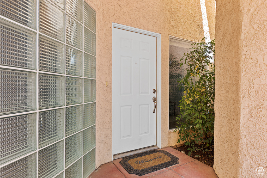 View of exterior entry with stucco siding