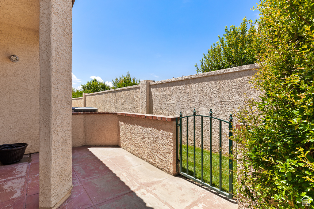 View of patio with a balcony