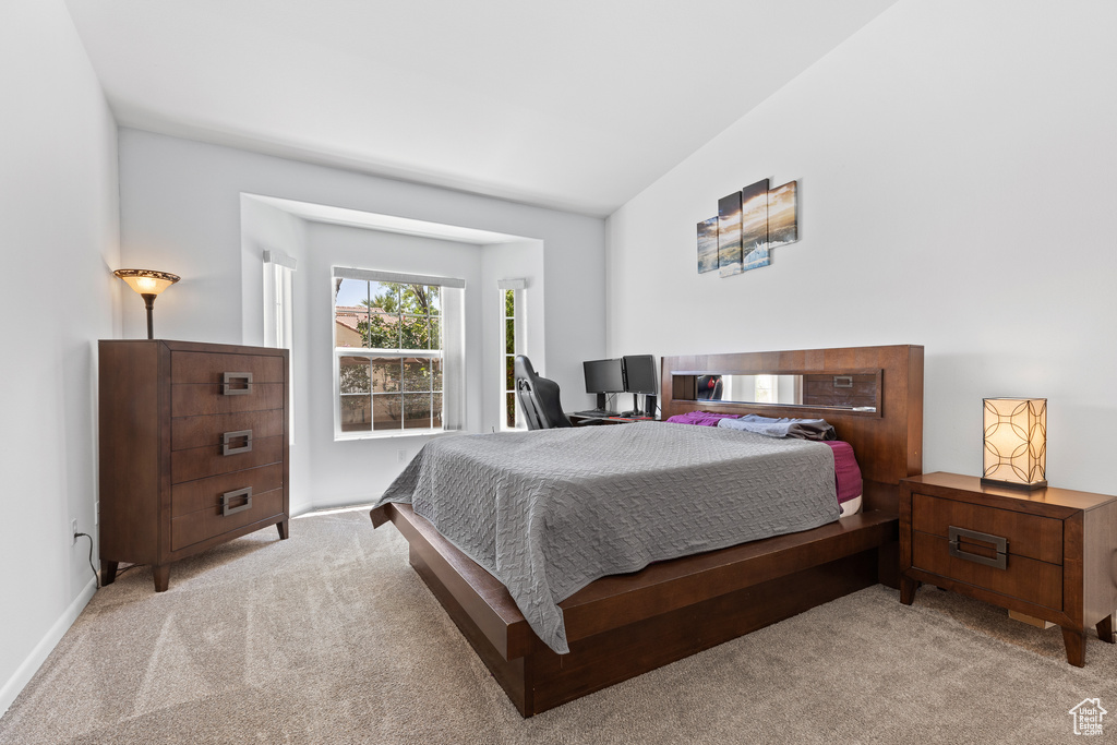 Bedroom featuring light colored carpet