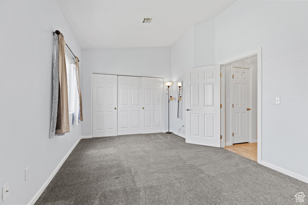 Unfurnished bedroom with carpet, baseboards, and a closet