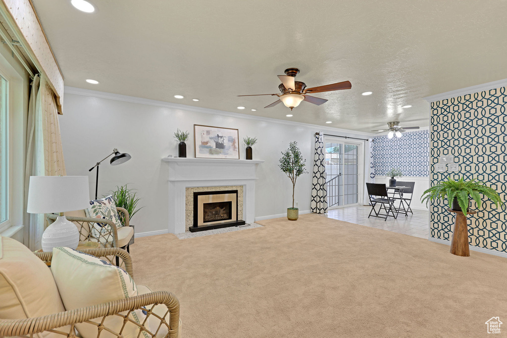 Living area featuring a ceiling fan, recessed lighting, carpet flooring, baseboards, and a fireplace with flush hearth