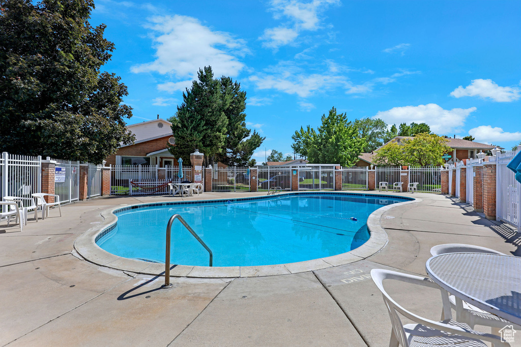 Community pool featuring a patio