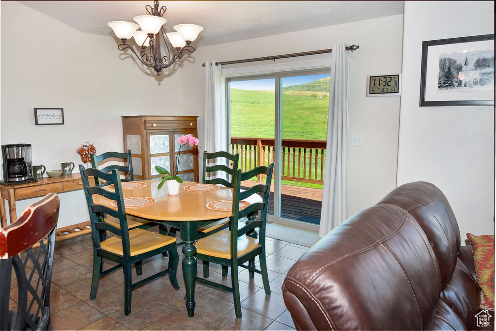 Dining area featuring a chandelier and tile patterned floors