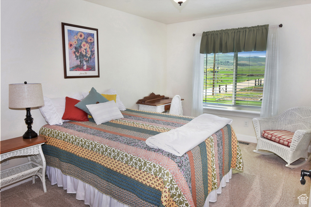 Carpeted bedroom featuring baseboards