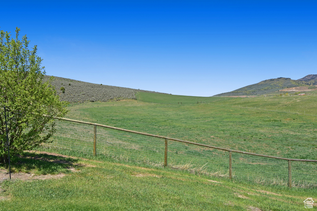 View of yard featuring a rural view and a mountain view