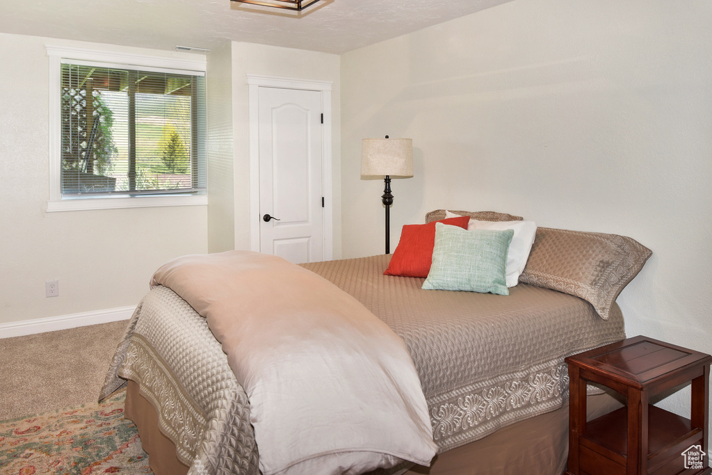 Bedroom with carpet flooring and baseboards