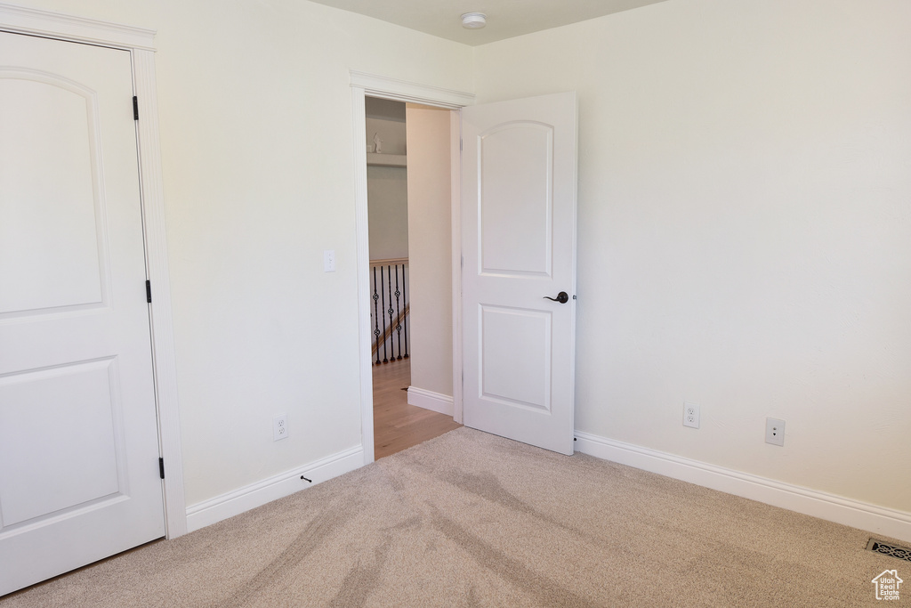 Unfurnished bedroom with carpet and baseboards