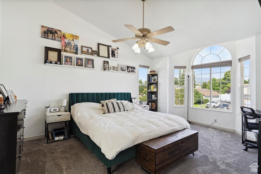 Bedroom featuring carpet flooring, vaulted ceiling, baseboards, and ceiling fan