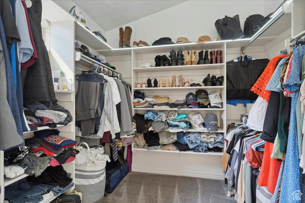 Walk in closet featuring carpet flooring and vaulted ceiling