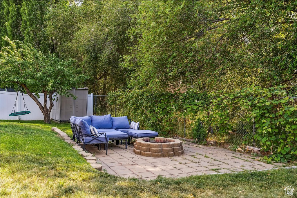 View of yard with a patio area and an outdoor living space with a fire pit