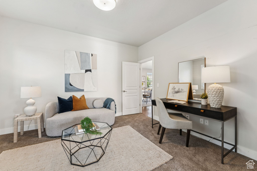 Carpeted office space with baseboards