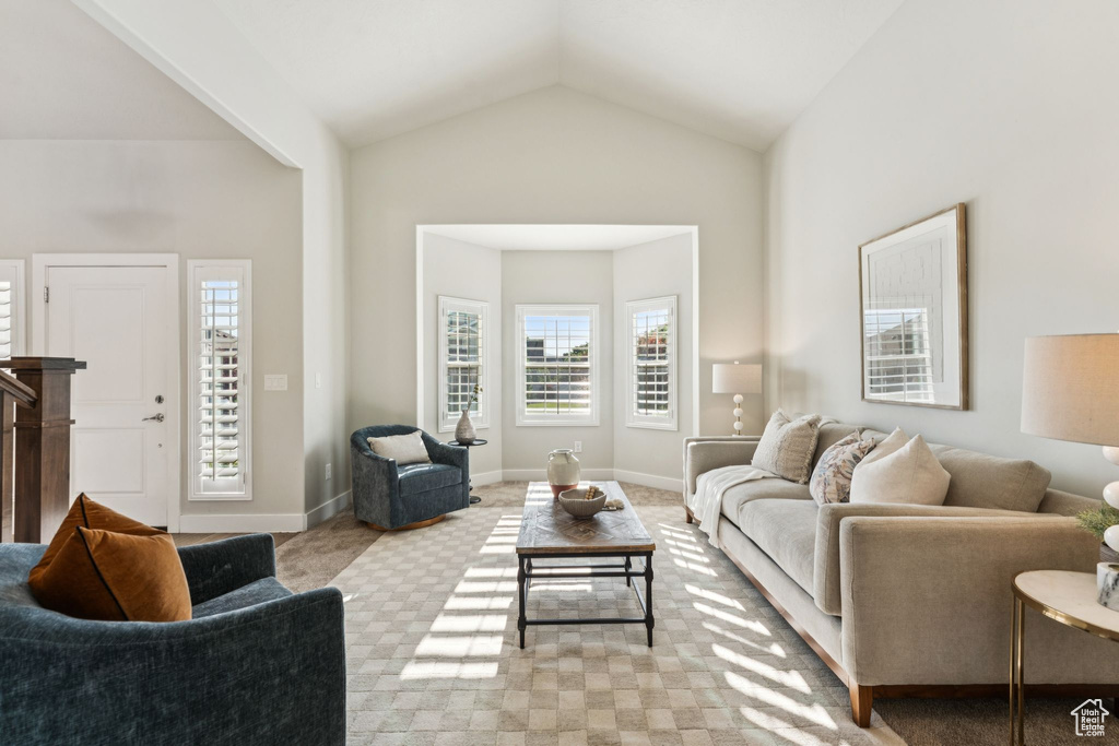 Living room with light colored carpet and lofted ceiling