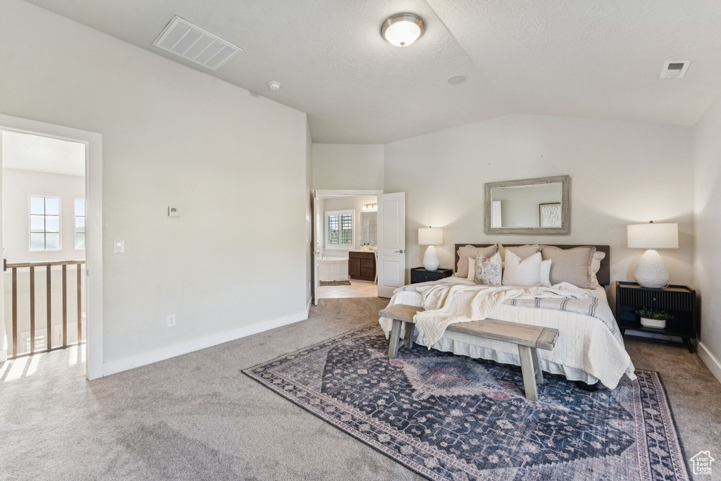 Bedroom with carpet floors, lofted ceiling, multiple windows, and baseboards
