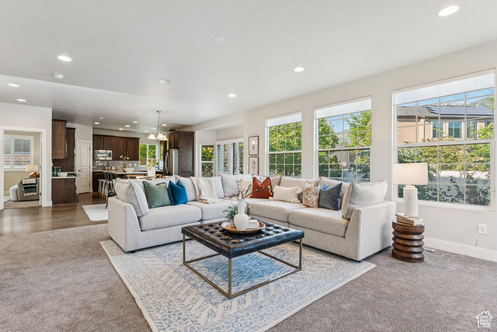 Living area featuring carpet, recessed lighting, healthy amount of natural light, and baseboards