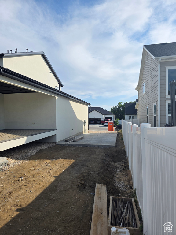 View of side of home with a deck
