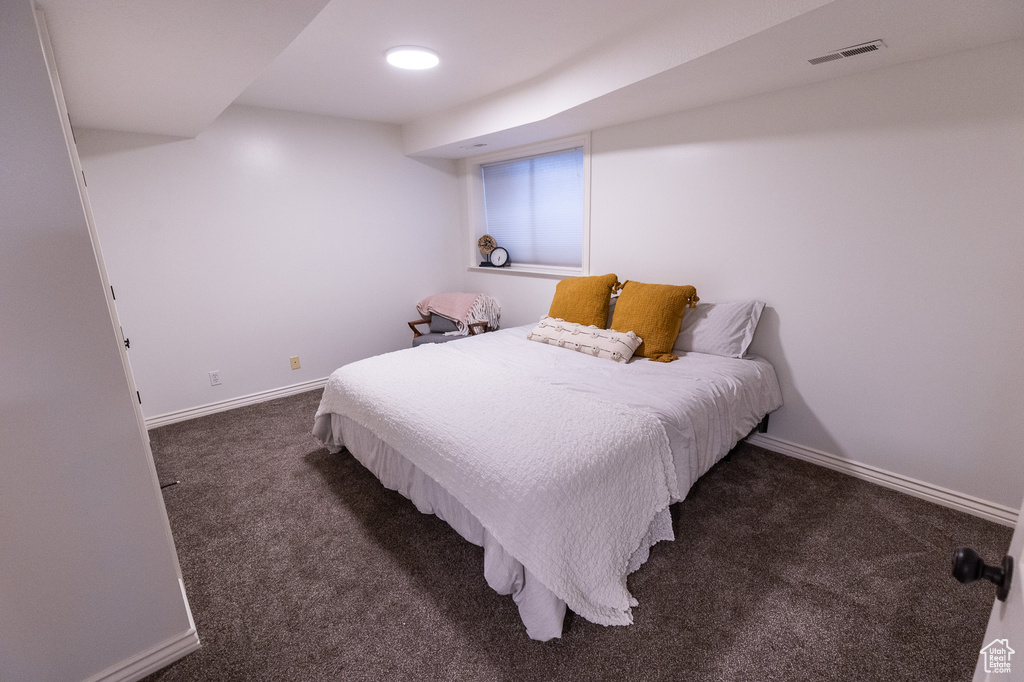 Bedroom featuring carpet flooring and baseboards