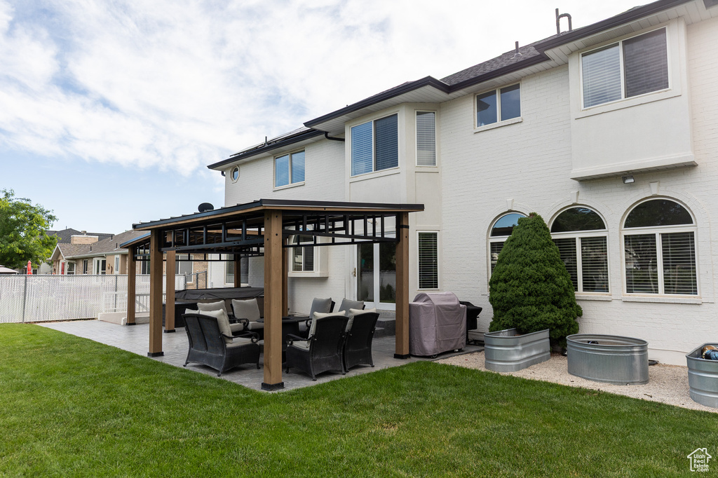 Rear view of house featuring outdoor lounge area, a patio area, and a gazebo