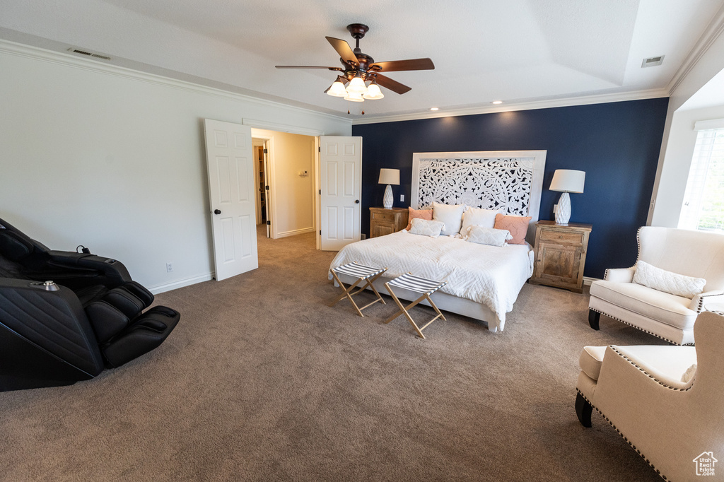 Bedroom featuring ornamental molding, carpet flooring, a raised ceiling, baseboards, and ceiling fan