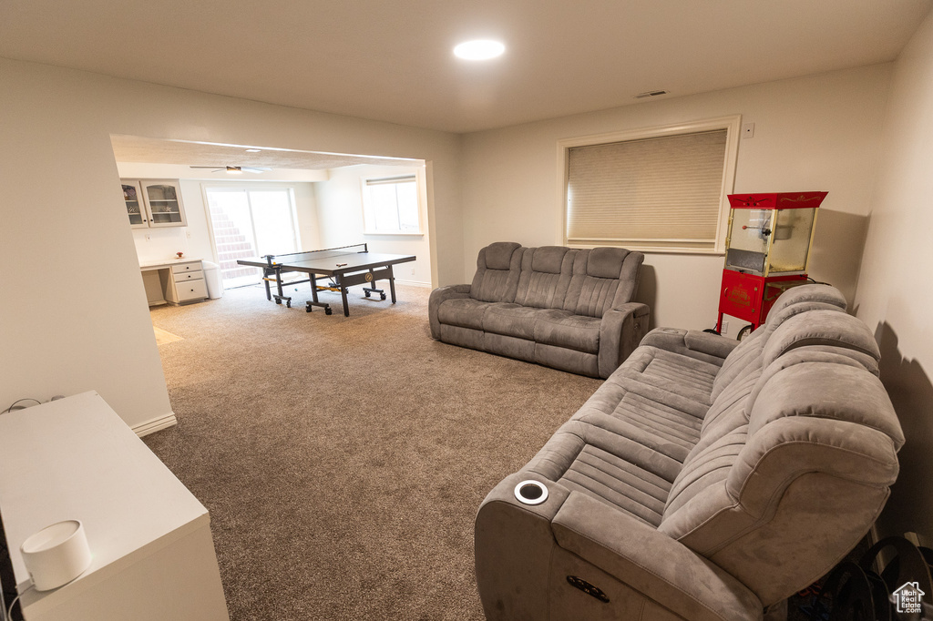 Living area with carpet floors and recessed lighting